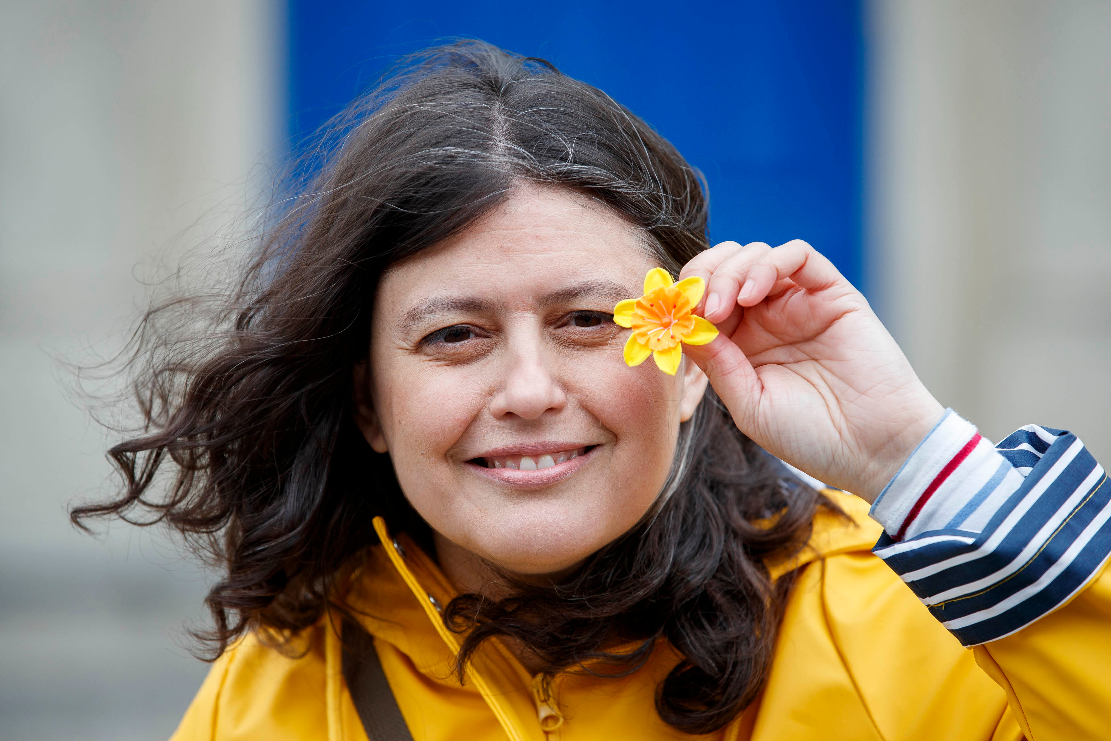 Woman holding a daffodil pin