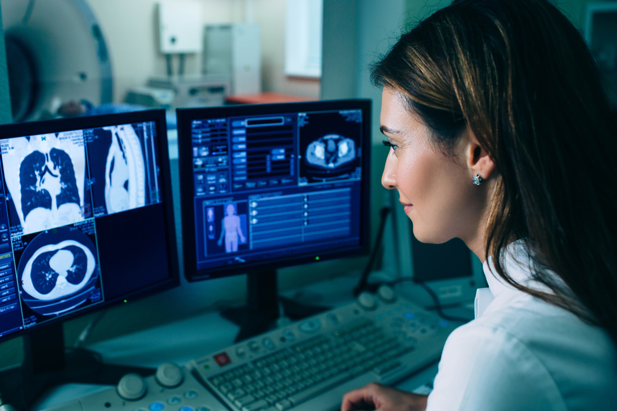 Doctor looking at scan pictures on a computer screen