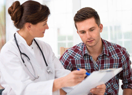 Doctor explaining something to a male patient