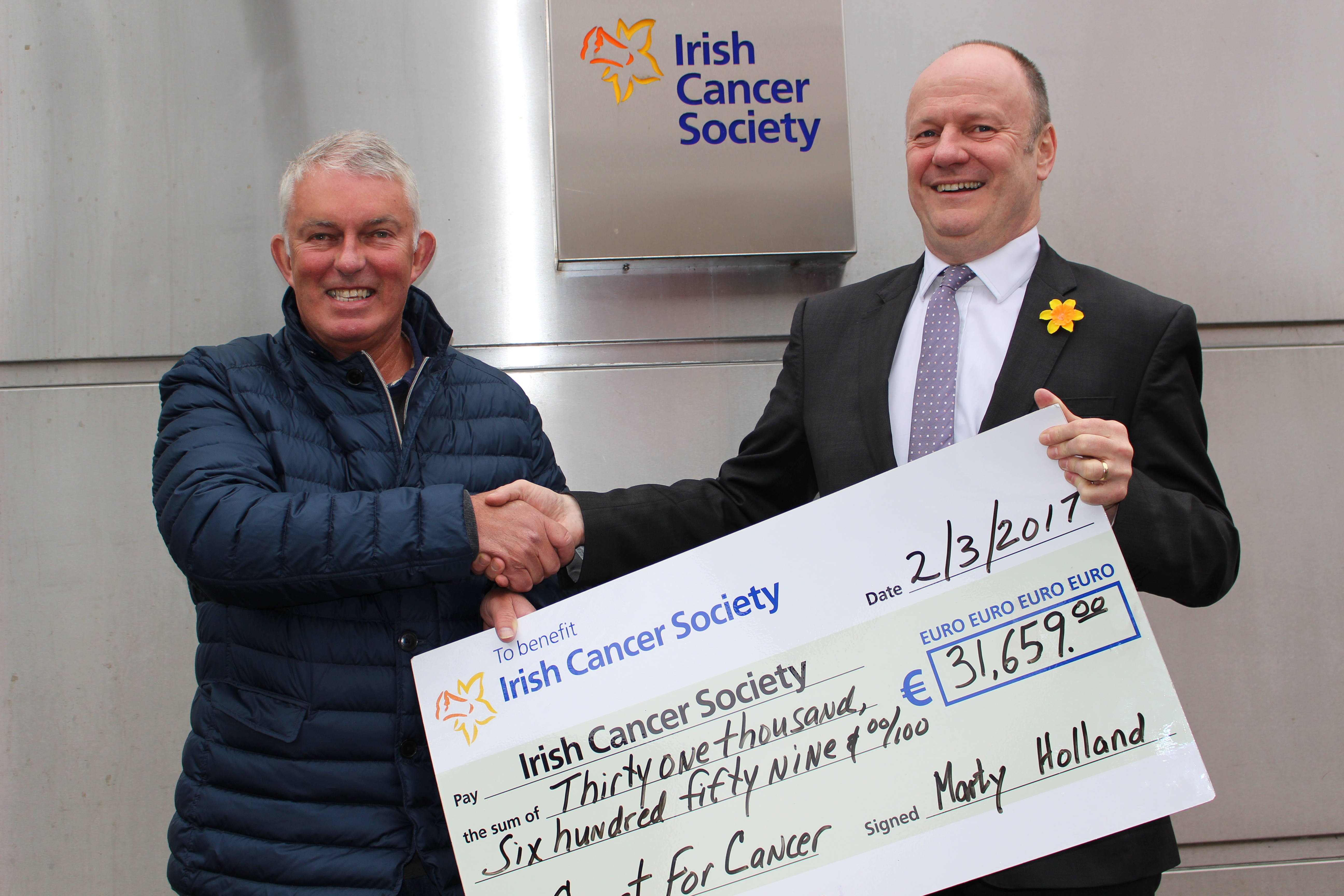 Fundraiser Marty Holland presenting a cheque