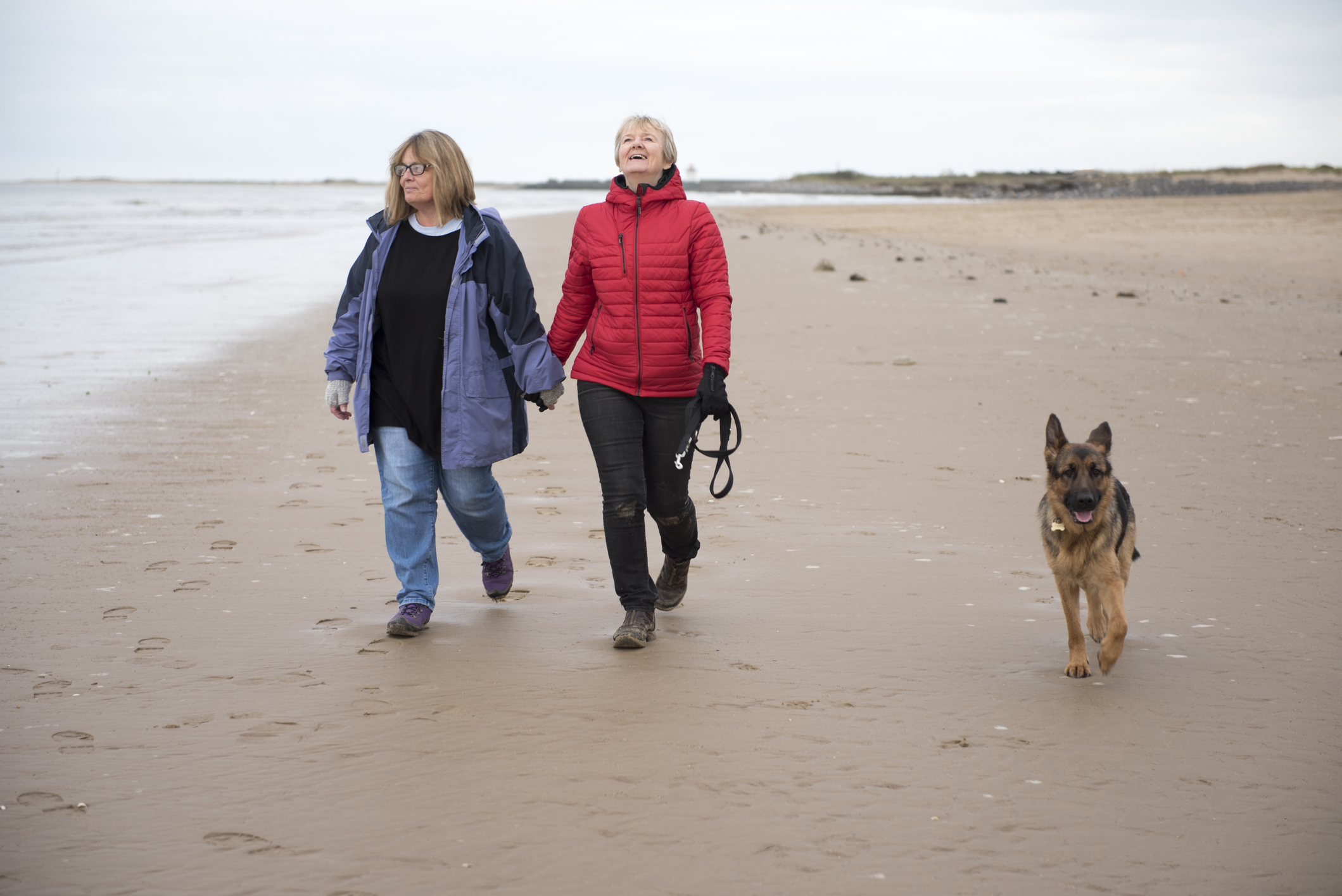 Older couple walking on the beach