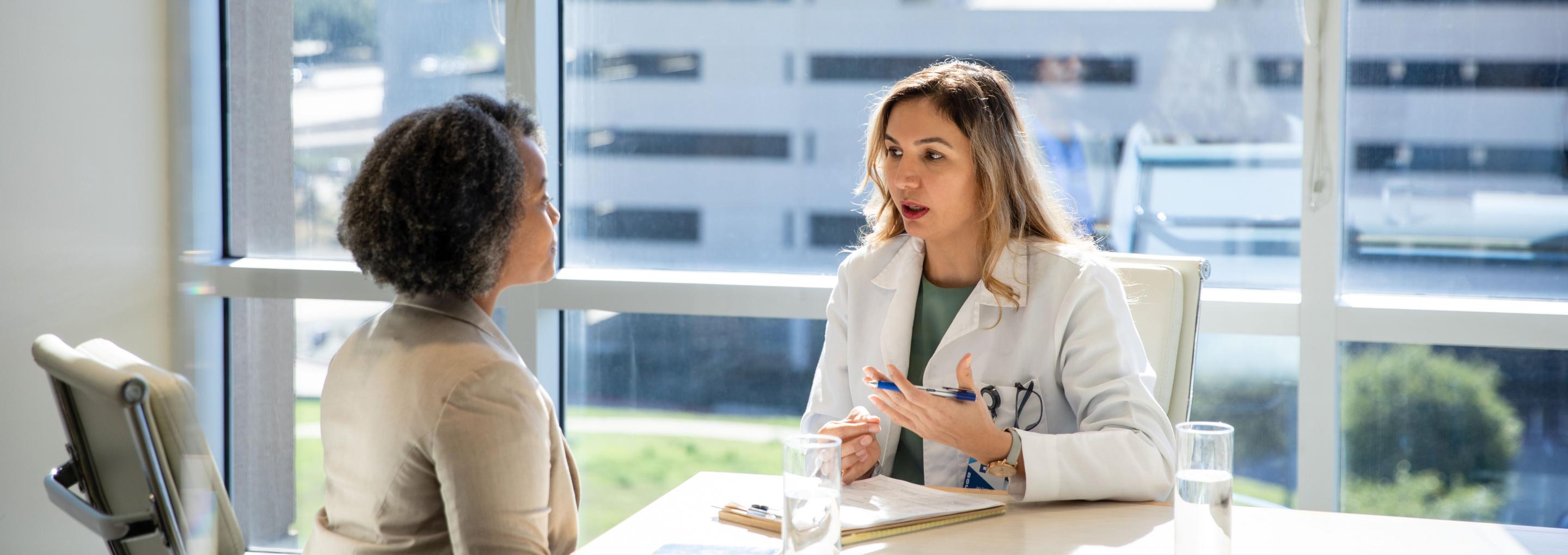 A consultant speaking with her patient