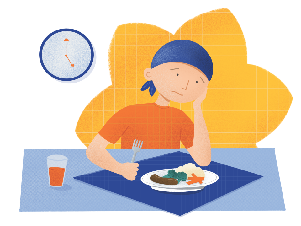 A boy at dinner looking unhappy
