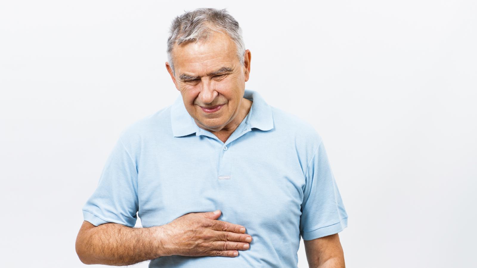Older man touching his stomach