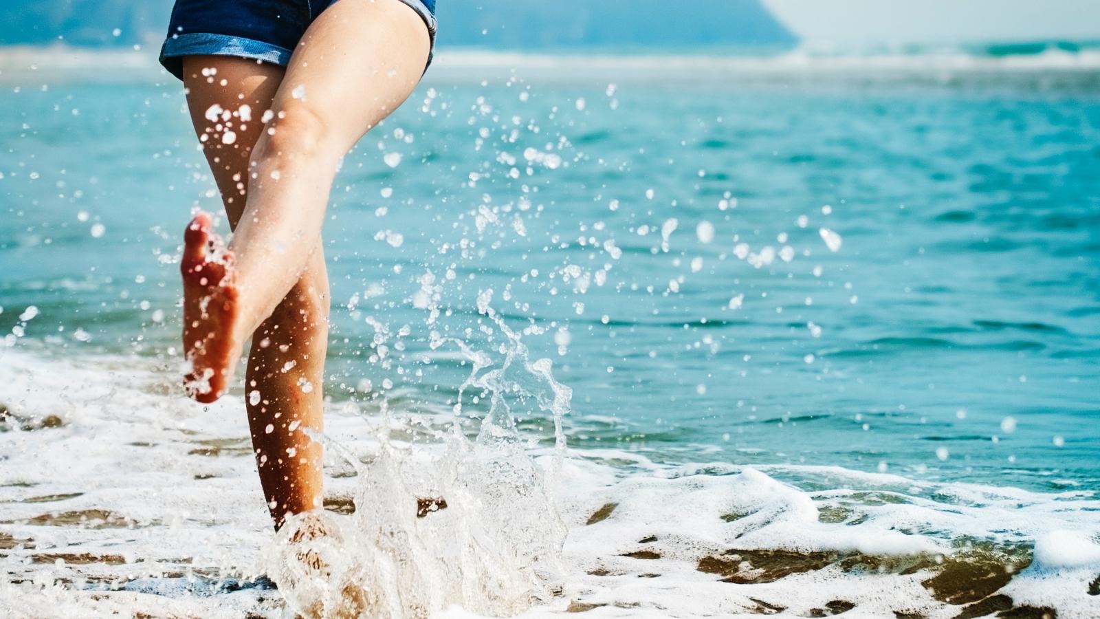 Woman barefoot on the beach