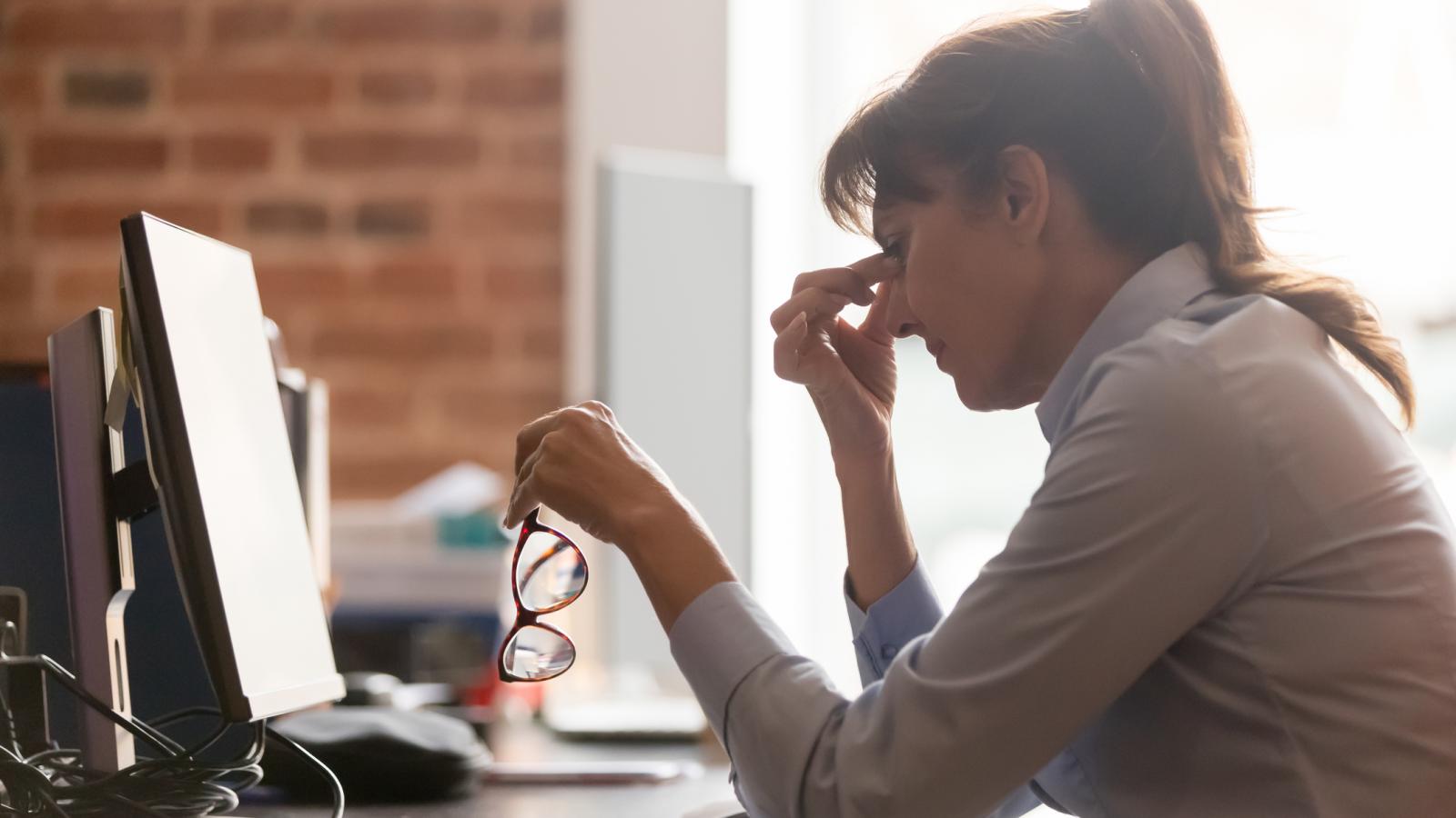 Woman in pain at her desk