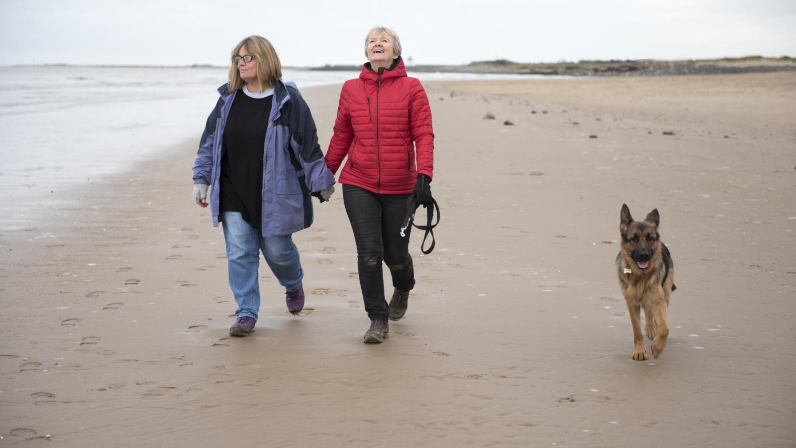 Older couple walking on the beach