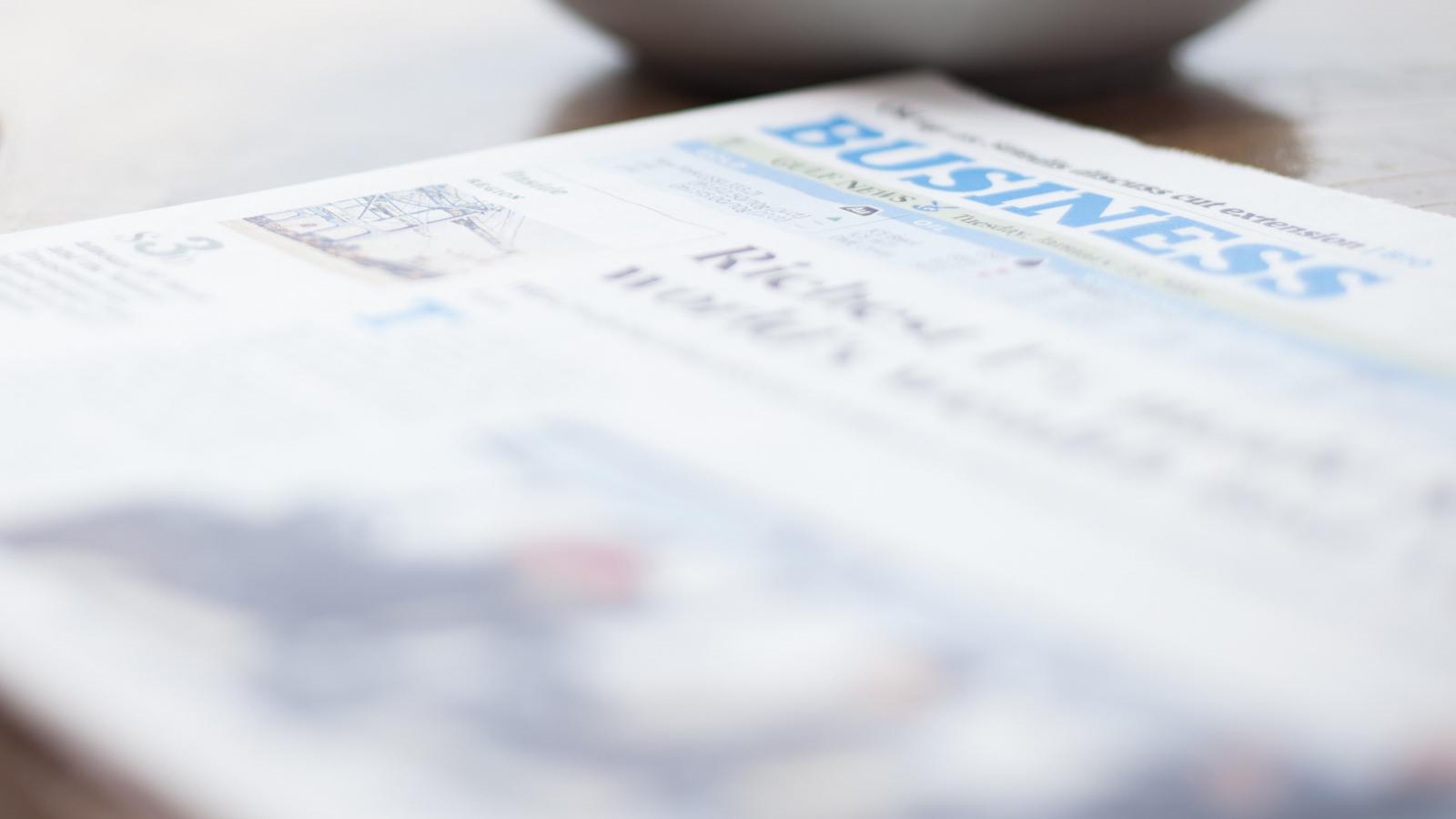Newspaper and coffee cup